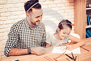 Happy Daughter with Father Draw Picture on Table.