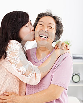 Happy daughter kissing her mother