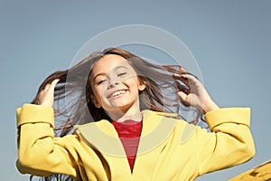 Happy day. Kid girl long hair enjoy walk sunny day blue sky background. Girl carefree childhood walk. Charming little
