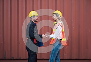 Happy dealing shaking hands two foreman man & woman worker working checking at Container cargo harbor to loading containers. Dock