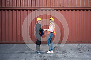 Happy dealing shaking hands two foreman man & woman worker working checking at Container cargo harbor to loading containers. Dock