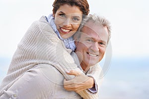 Happy and deeply in love. Portrait of a loving mature couple embracing and smiling happily.