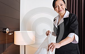 Happy delighted woman working as a hotel maid