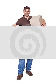 Happy Delivery Man Holding Cardbox And Placard