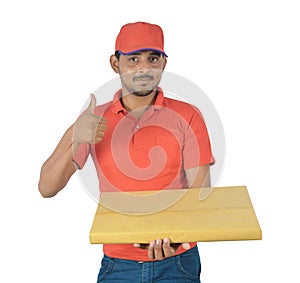 Happy delivery man holding gift pack, thumb up in uniform