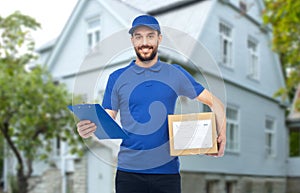 Happy delivery man with parcel box and clipboard