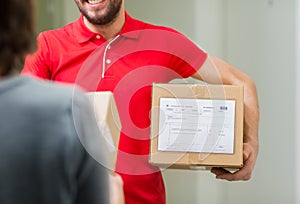 Happy delivery man with parcel box and customer