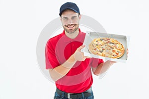 Happy delivery man showing fresh pizza