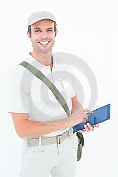 Happy delivery man using digital tablet
