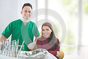 Happy dentist with cheerful patient
