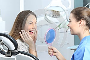 Happy dentist patient checking whitening results