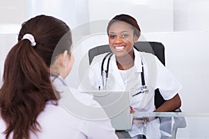 Happy Dentist Talking To Patient