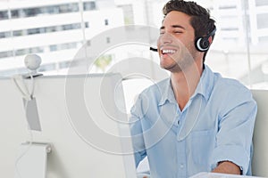 Happy designer laughing during an online communication