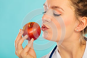 Happy dietitian nutritionist with apple fruit.