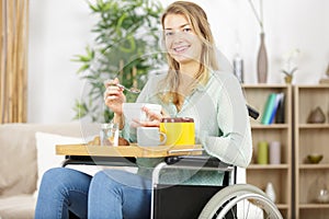 happy disable woman having cereals in morning