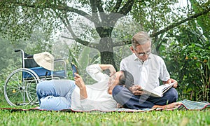 Happy disabled grandfather relaxing with granddaughter outdoor at the park. Family happy lifestyle