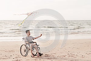 Happy disabled kid concept outdoor at the beach