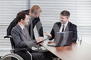 Happy disabled man during business meeting