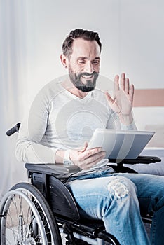 Happy disabled man talking with friends