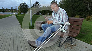 Happy disabled man using smart phone