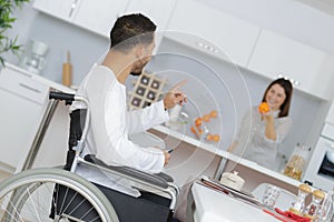 Happy disabled man with wife at home photo