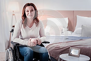 Happy disabled woman drinking coffee