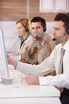 Happy dispatcher working in call center smiling