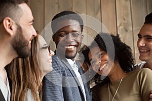 Happy diverse black and white people group smiling bonding toget