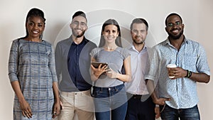 Happy diverse business people or students standing looking at camera