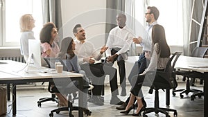 Happy diverse business team employees having fun at corporate meeting photo