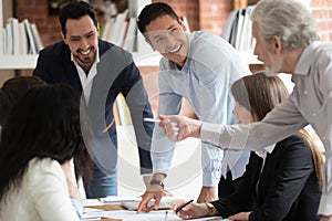 Happy diverse business team talking gather at conference table