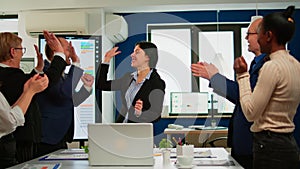 Happy diverse businesspeople giving high five during team corporate brainstorm
