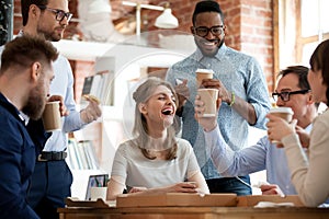 Happy diverse colleagues celebrate during lunch break in office