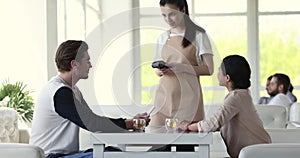 Happy diverse couple of customers dating in cafe