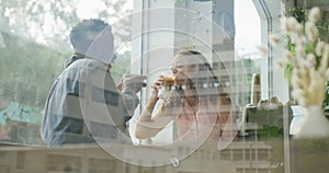 Happy diverse couple spending time together at cafe, drinking coffee and talking