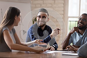 Happy diverse creative business team people talking at group meeting