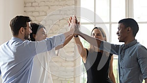 Happy diverse employees team giving high five, celebrating success