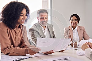 Happy diverse executive business people checking document at meeting in office.