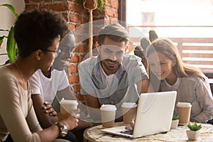 Happy diverse friends group looking at laptop watching comedy movie