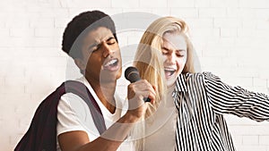 Happy diverse friends singing together at home