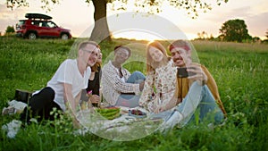 Happy Diverse Friends are taking Selfie at picnic in park or stop on road trip