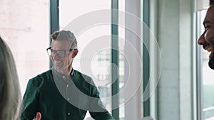 Happy diverse international employees team people give high five in slow motion.