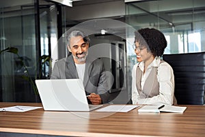 Happy diverse professional business people working in office with laptop.