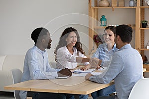 Happy diverse recruit team and job candidate shaking hands