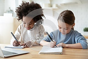 Happy diverse sisters study together online at home