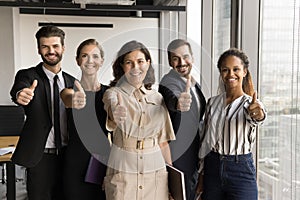 Happy diverse team and mature female leader posing for portrait