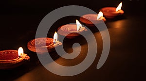 Diwali, Hindu festival of lights celebration. Diya oil lamps against dark background photo