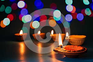 Happy Diwali - Clay Diya lamps lit during Dipavali