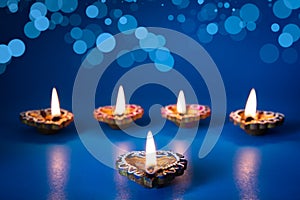 Happy Diwali - Clay Diya lamps lit during Dipavali