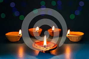 Happy Diwali - Clay Diya lamps lit during Dipavali